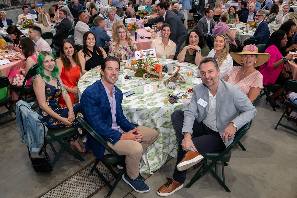 Group of people at a table at the Soiree Event